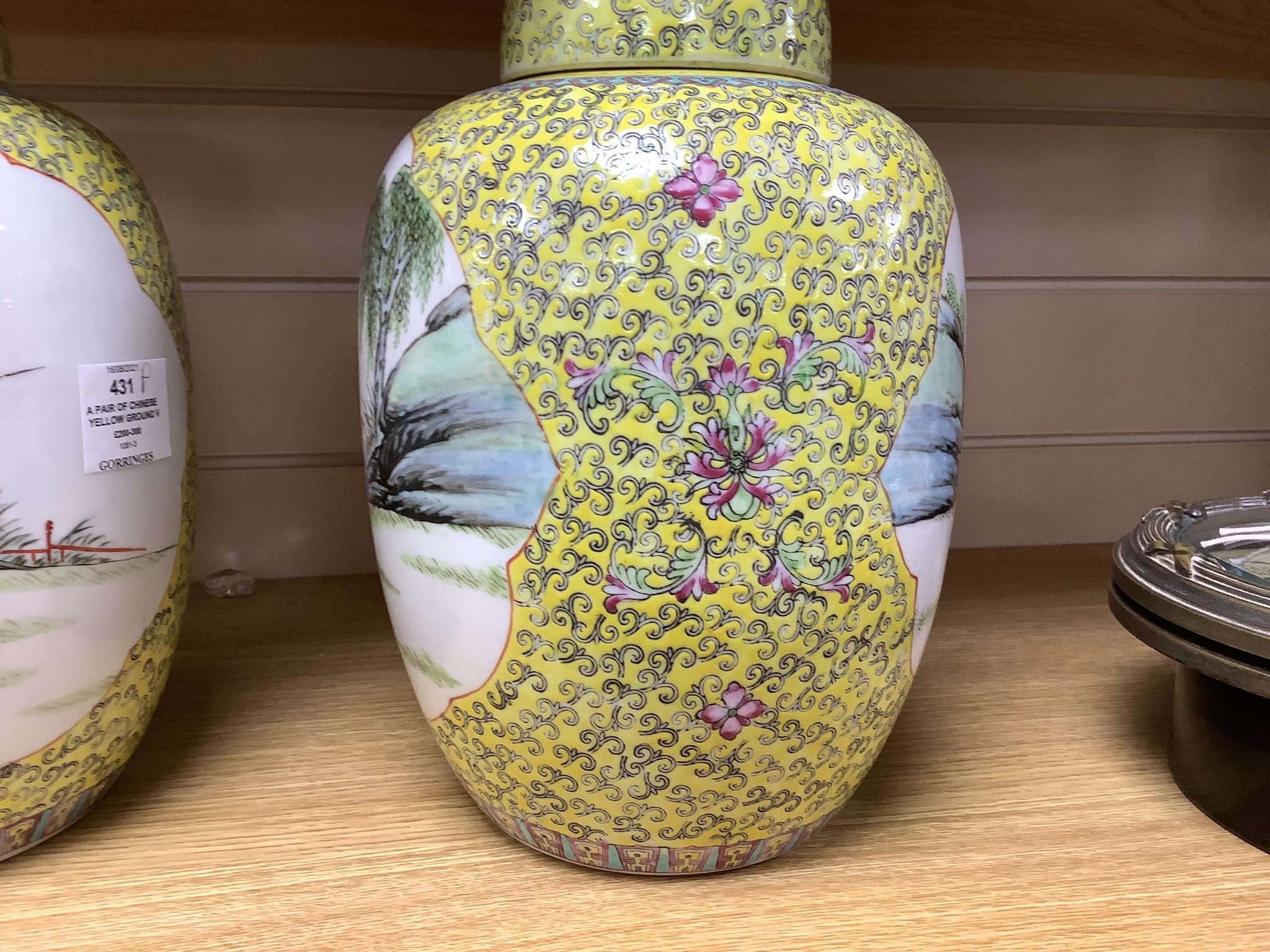 A pair of Chinese yellow ground vases and covers, height 30cm
